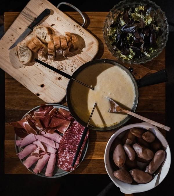 Some classic garnishes for cheese fondue. Photo by Yann Allegre