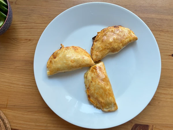 Vegetarian empanadas filled with beans, corn, peppers, carrots and cheese.