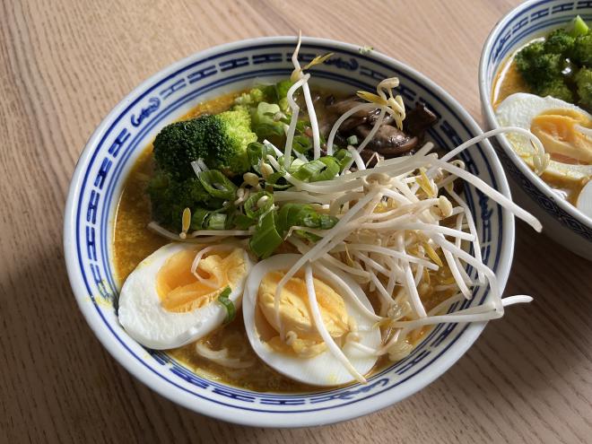 Firecracker ramen with a topping of egg, sprouts, broccoli and mushrooms.