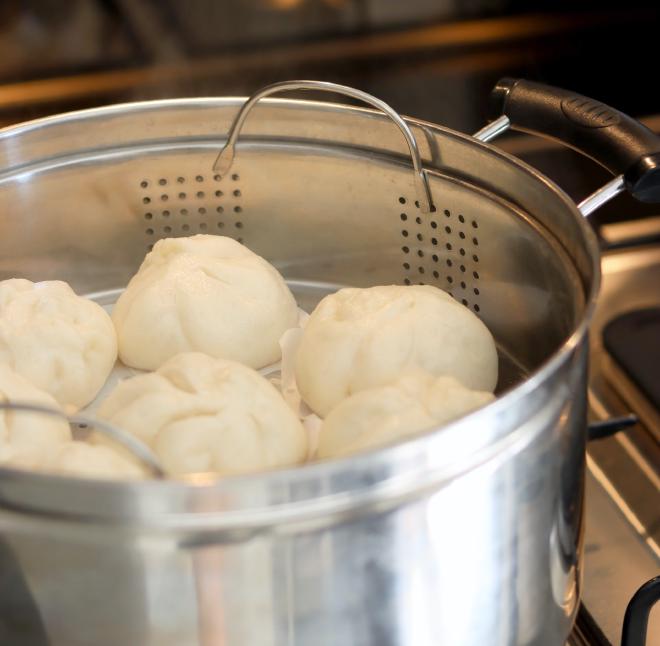 Baos being steamed in a pot