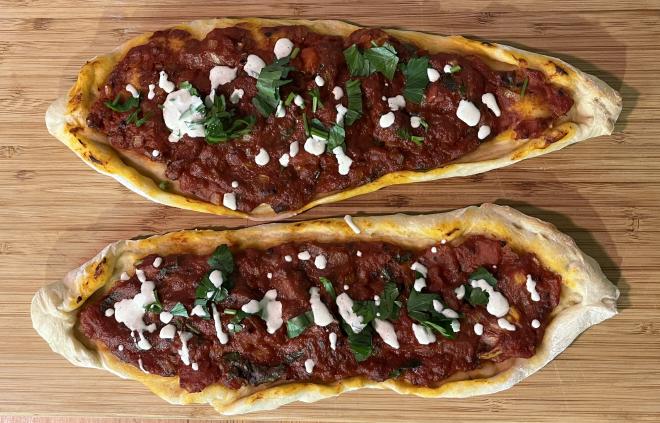 Two pide, fresh from the oven with a little yoghurt sauce and parsley